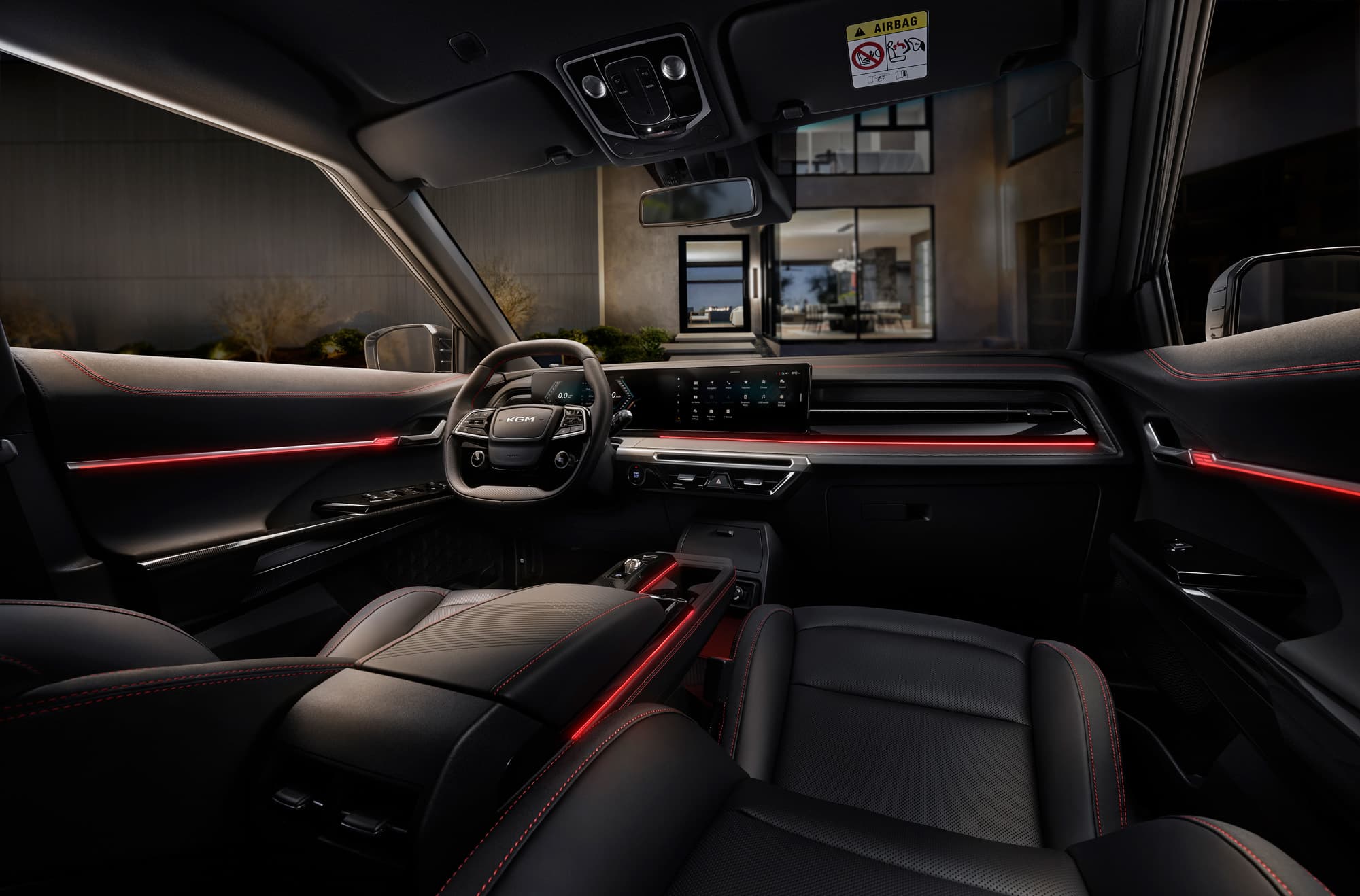Sleek black leather car interior with red ambient lighting, digital dashboard and steering wheel, view of a modern house through the windshield.